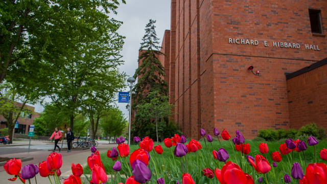 Hibbard Hall on a spring day with tulips blooming.