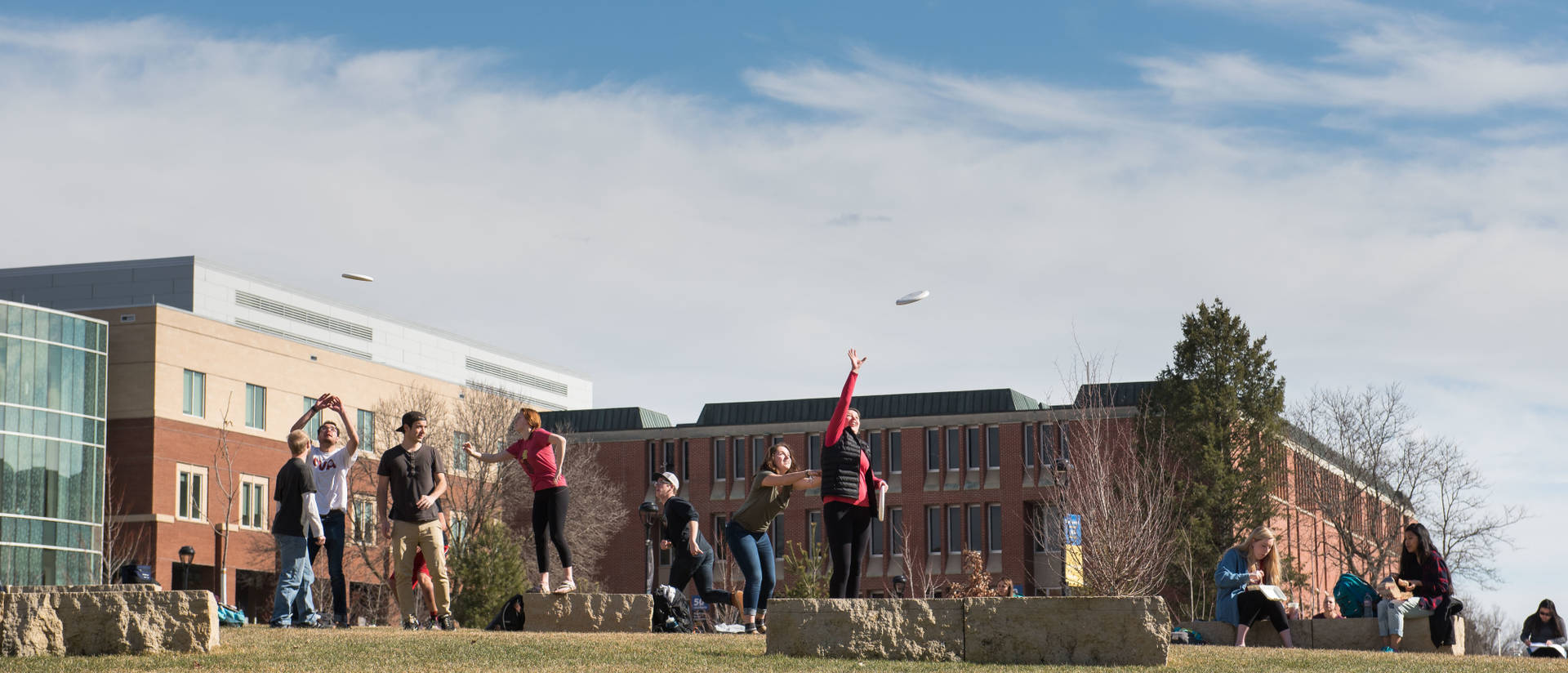 Students playing Frisbee in the campus mall