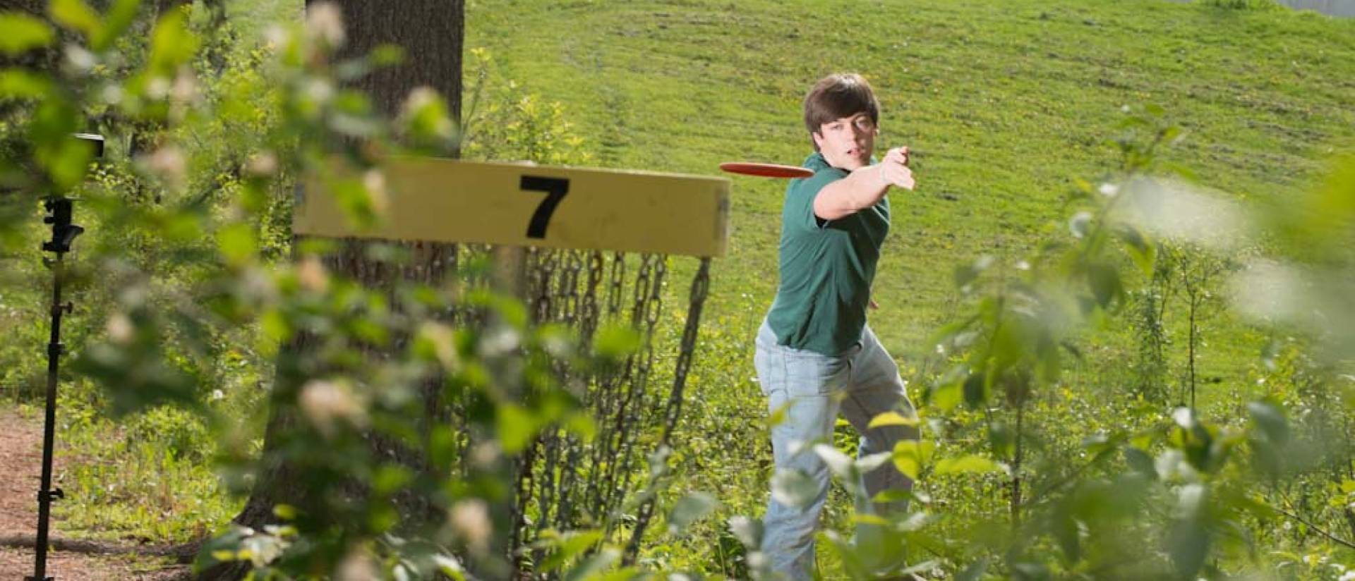 Student playing disc golf