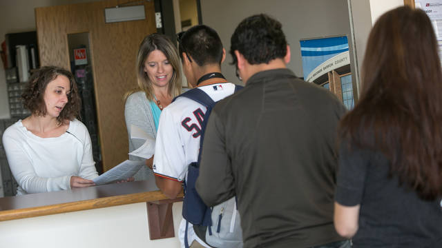 Line of students at Solution Center desk, Rice Lake campus