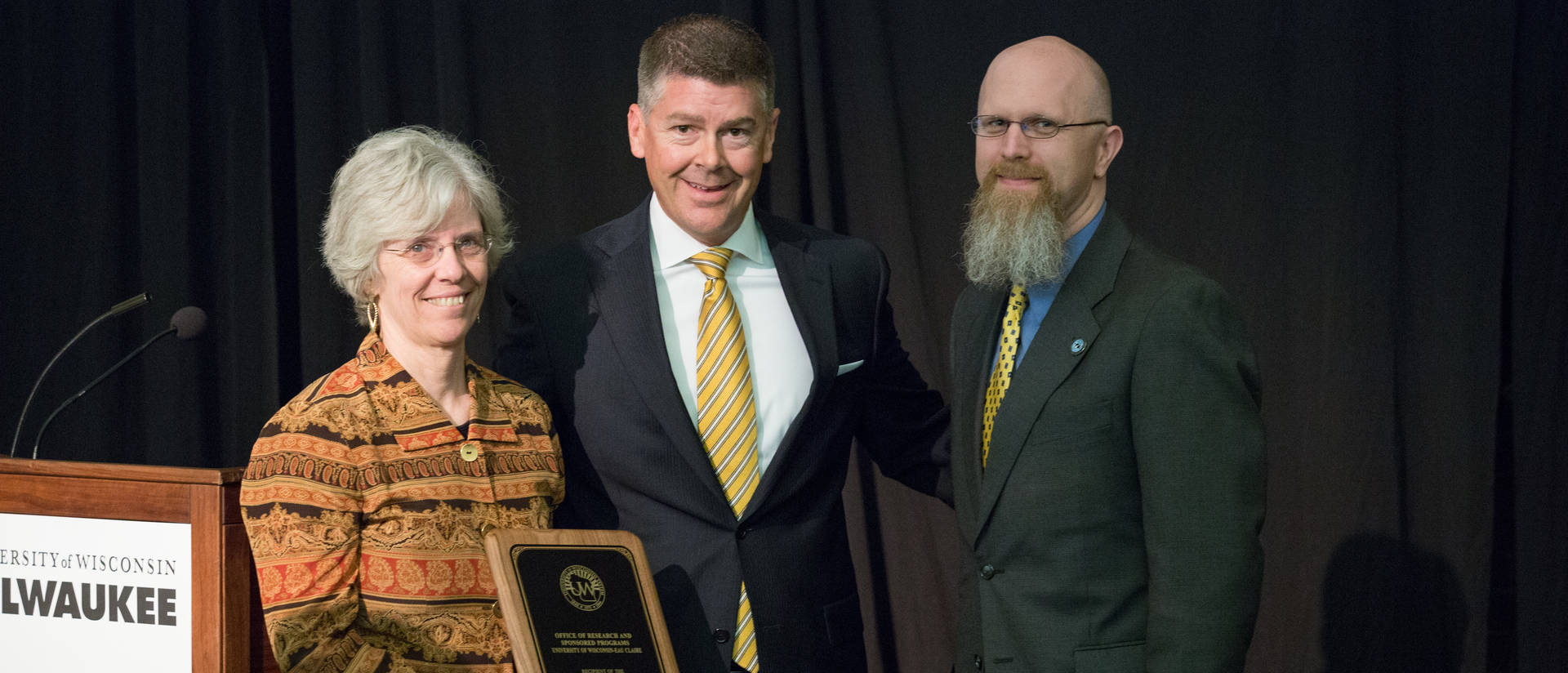 UW-Eau Claire's Karen Havholm, Assistant Vice Chancellor (left), and Director of Grants and Contracts, Jeremy Miner (right), with Regent Director Drew Peterson (middle)