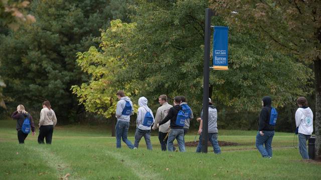 UW-Eau Claire – Barron County students walk outside across campus on a fall day.