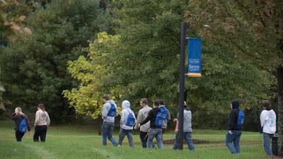 UW-Eau Claire – Barron County students walk outside across campus on a fall day.