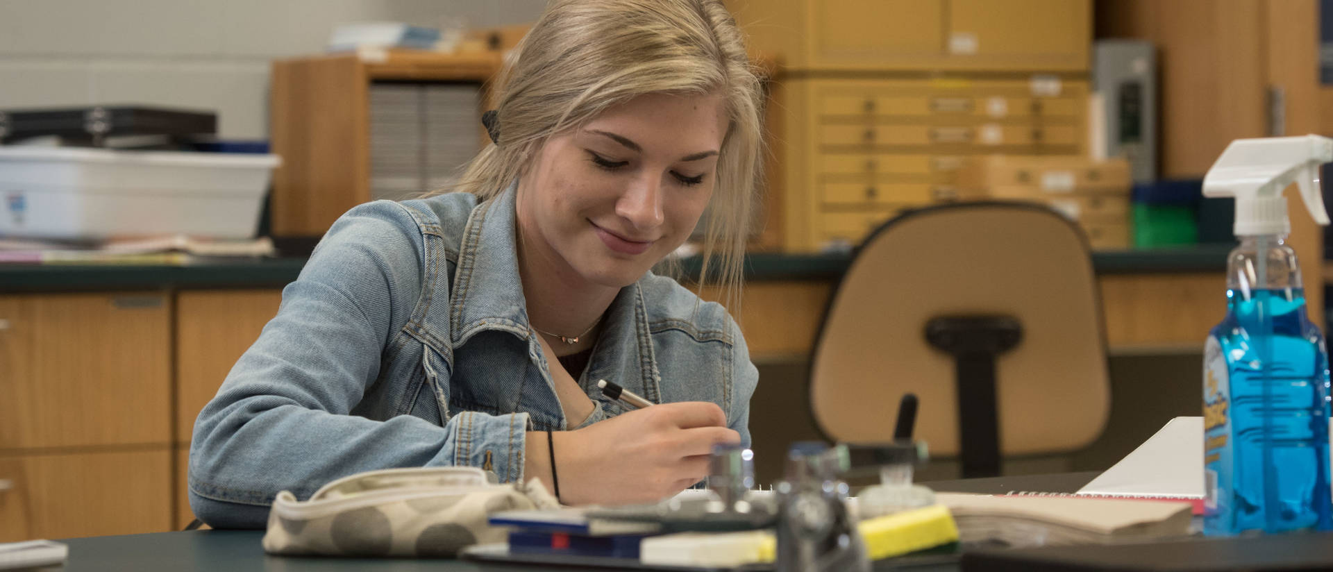 UW-Eau Claire – Barron County student takes note during science lab.