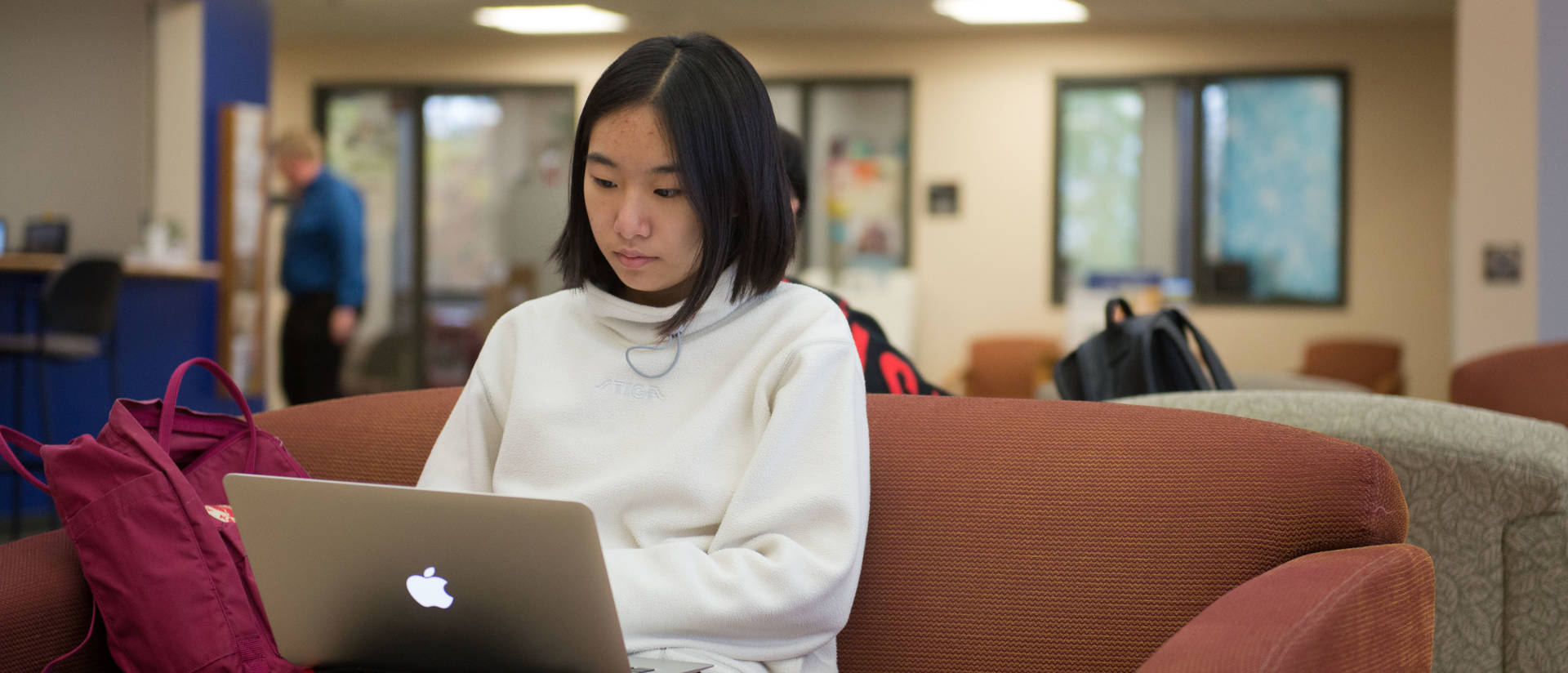 UW-Eau Claire – Barron County student studies in the commons area.