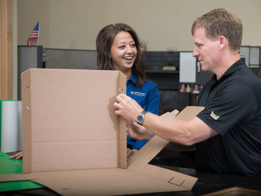 Woman and man working together to fold box