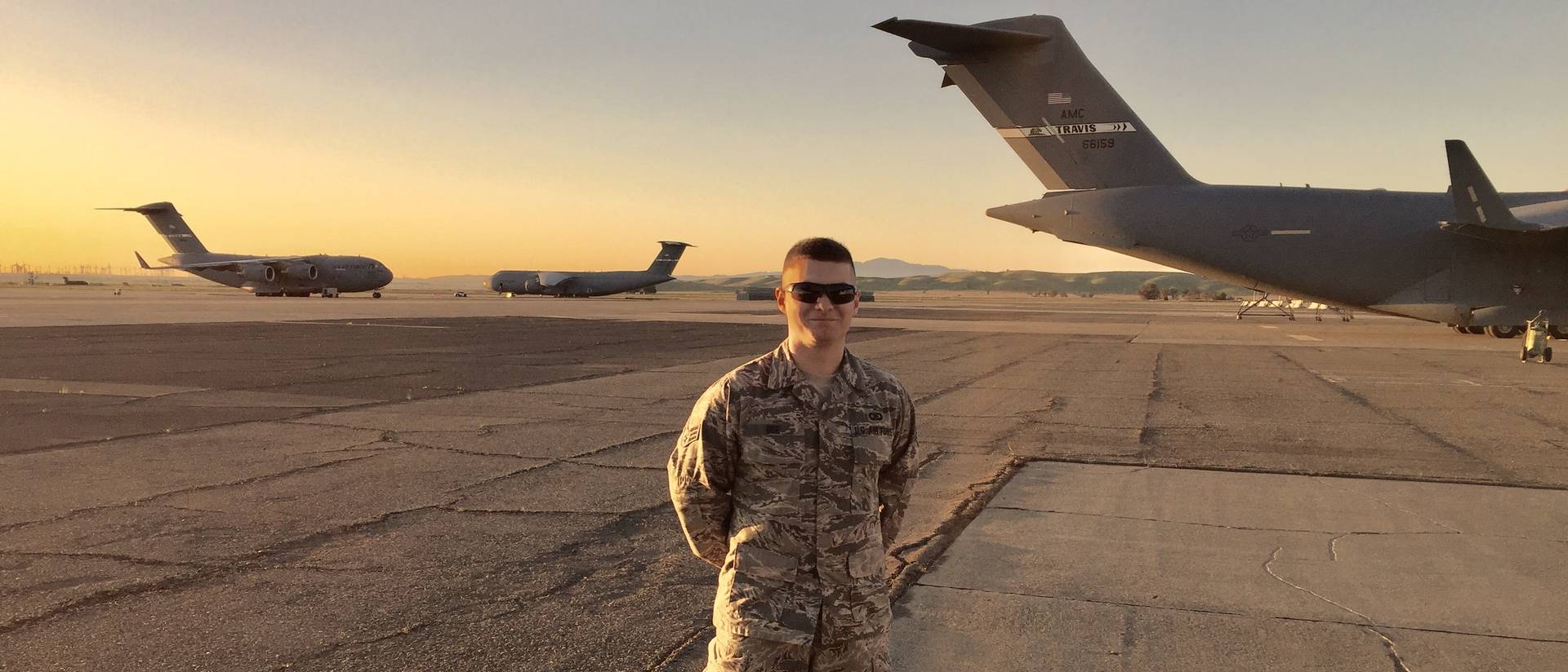 Senior Tyler Bee on the tarmak with Air Force planes