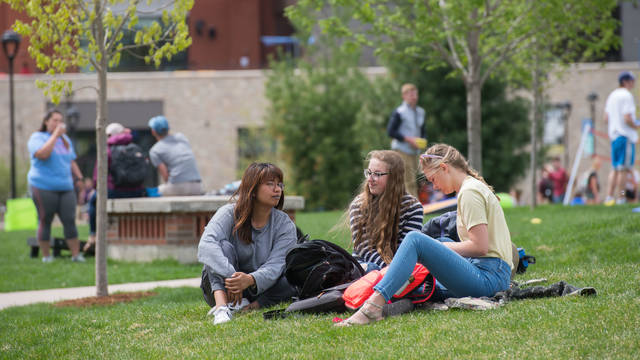 UWEC students study in campus mall on a spring day.