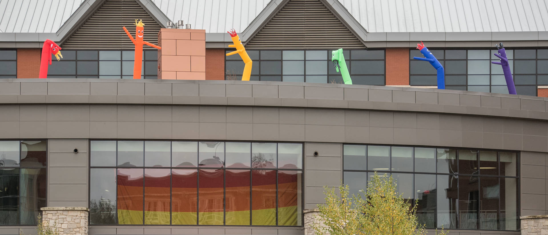 PRIDE flag and inflated people on Davies Center