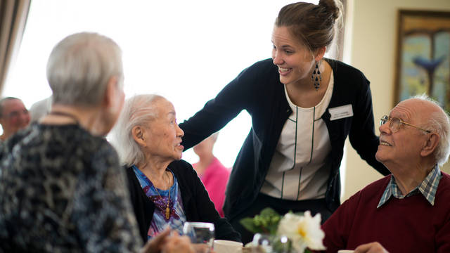 administrator helping elderly