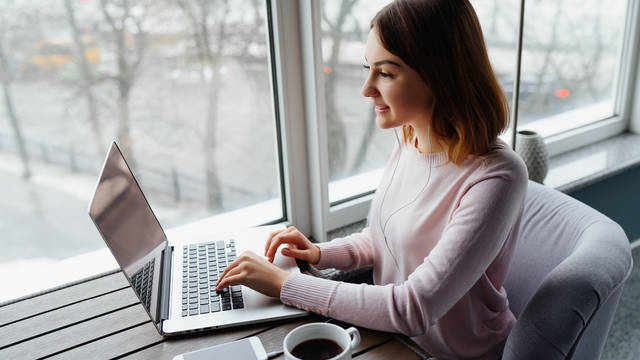 woman typing on laptop