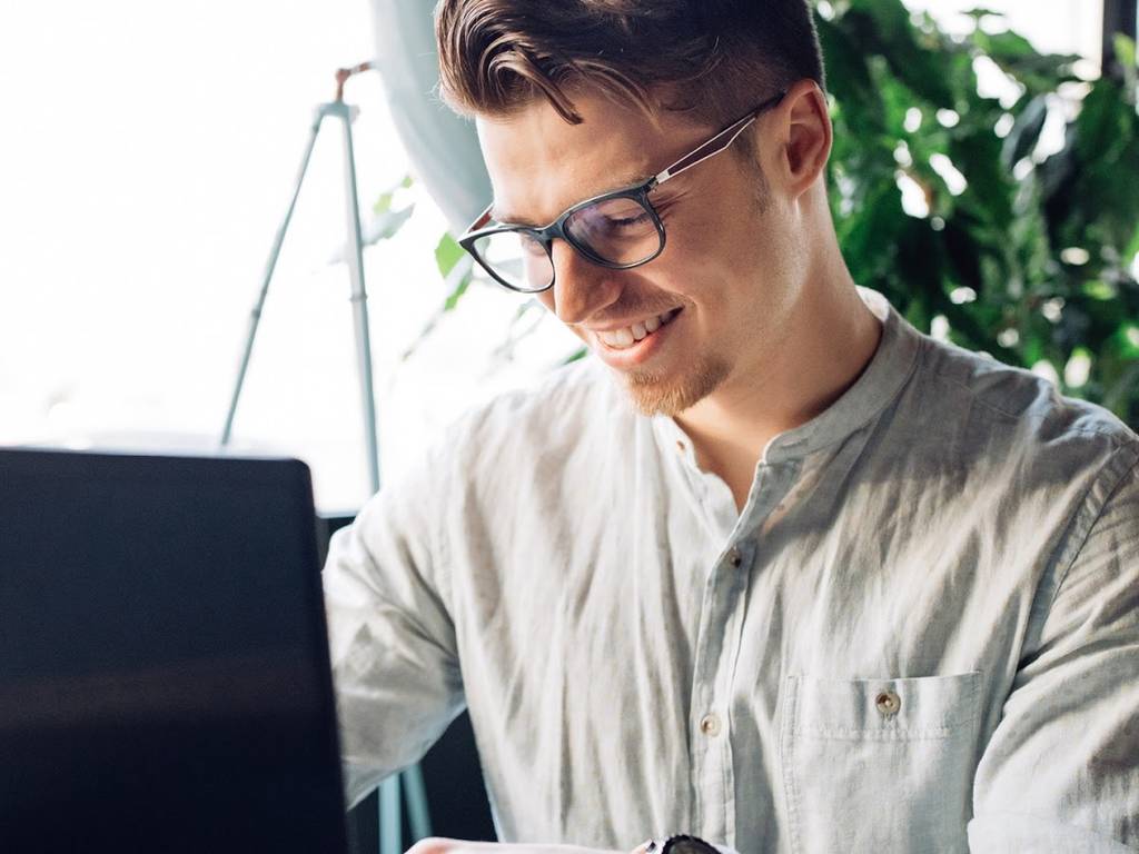 man typing on laptop