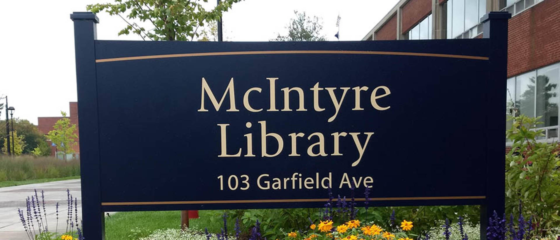 Flowers around McIntyre Library sign