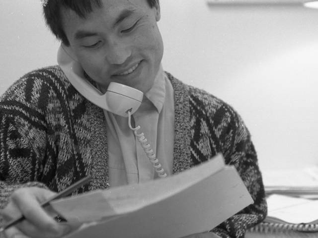 Charles Vue, '89 social work alumnus, in his 1990 office with the Eau Claire County Health Department