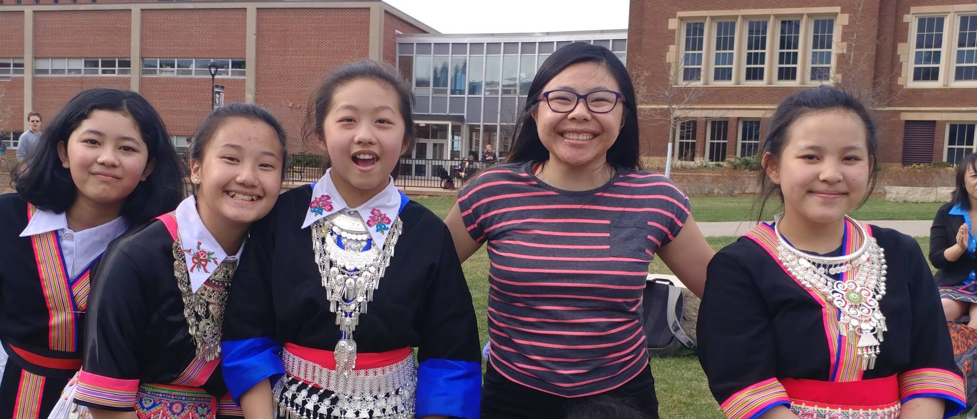 Gaoki Lee and Delong Middle School Hmong dancers on campus mall