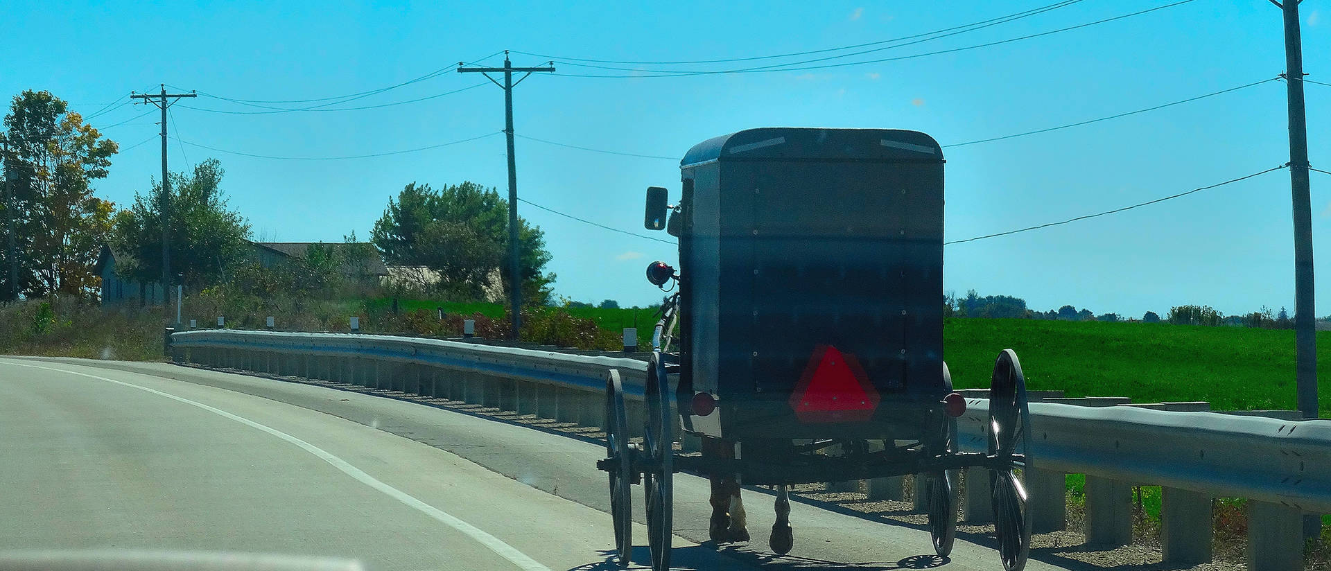 An Amish buggy travels on U.S. Highway 61. (Photo credit: Corey Coyle, Wikimedia Commons)