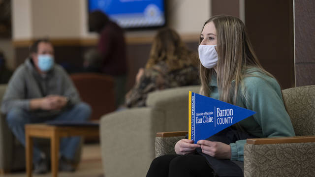 Student holding pennant during visit on UWEC–BC campus in Rice Lake