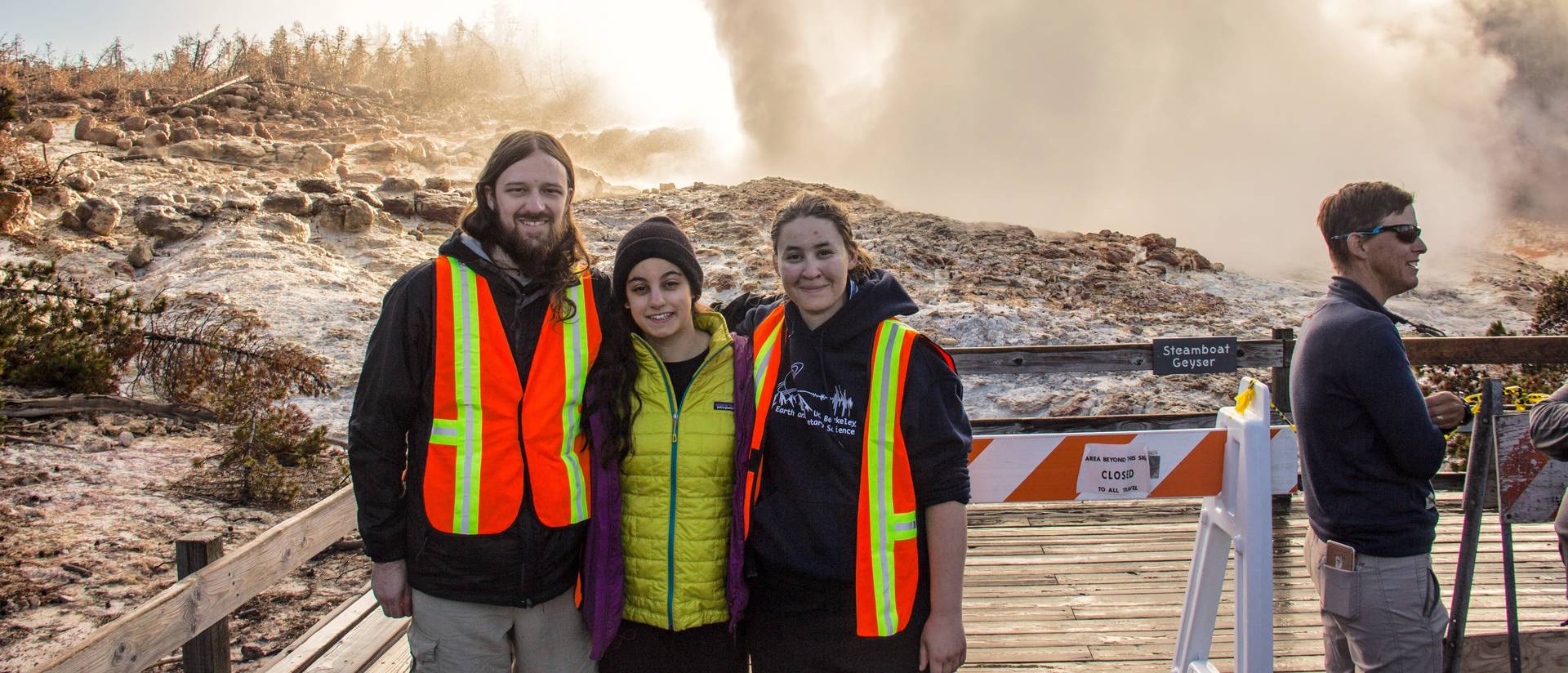 UW-Eau Claire grad Mara Reed (right) stands in front of Steamboat Geyser in Yellowstone National Park. Reed’s research about geyser’s more frequent eruptions is gaining national attention. (Photo by Carol Beverly)