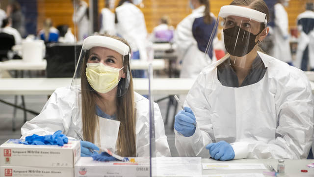 Student nurses working vaccine clinic on Zorn Arena