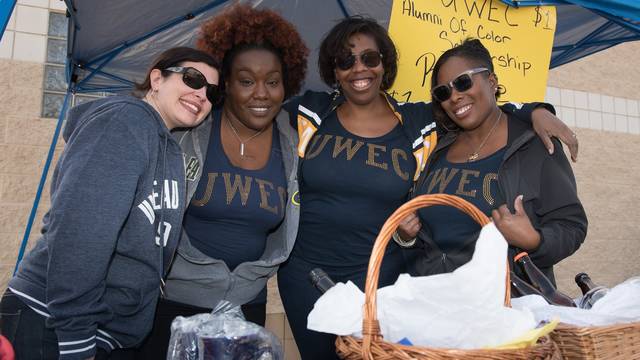 Members of the Alumni of Color Network operate a raffle at the 2015 Homecoming game to raise money for the organization’s Social Justice and Inclusion Scholarship.