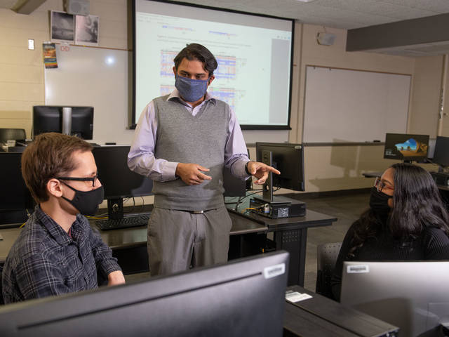 Dr. Rahul Gomes and two students