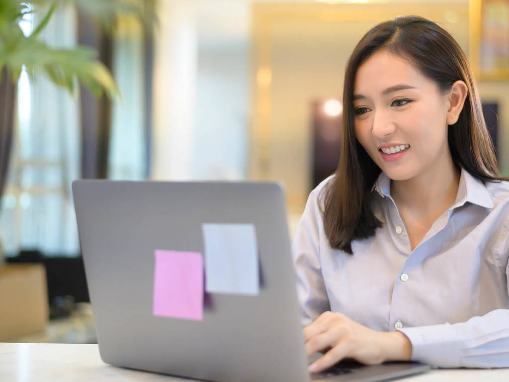 woman typing on a laptop