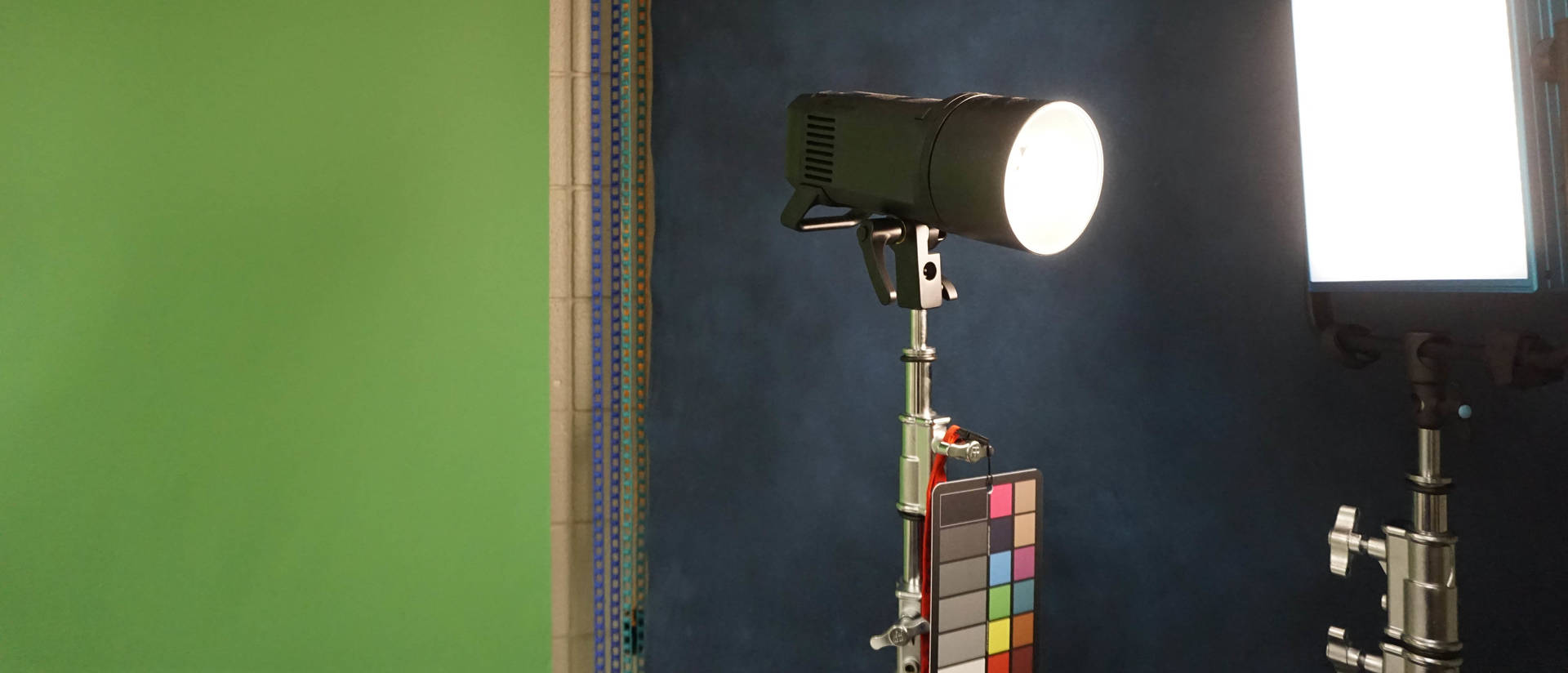 Two photography lights against a green screen