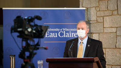 Chancellor being filmed for Blugold Breakfast speech, mask on