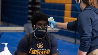 Student having temperature taken on forehead