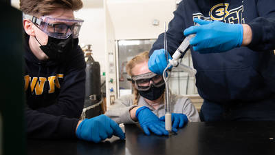 Foam research in matsci alb, two male students and one femle injecting liquid foam