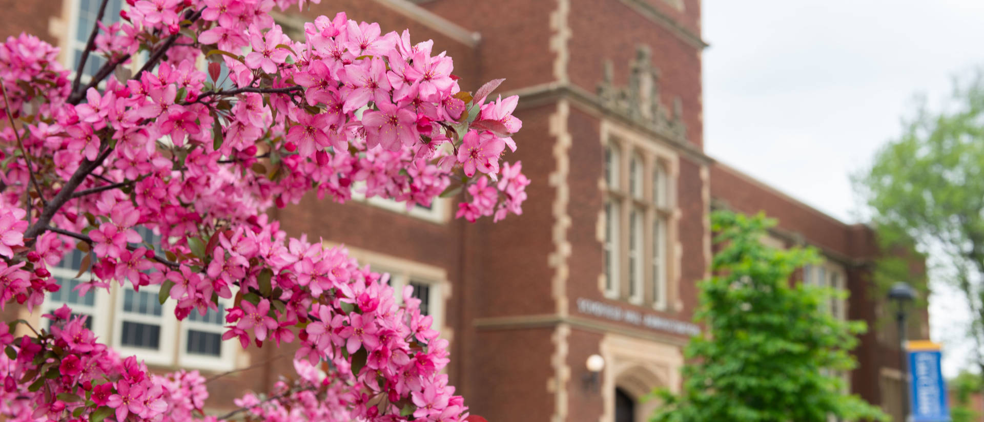 Schofield Hall in the spring with trees blooming.