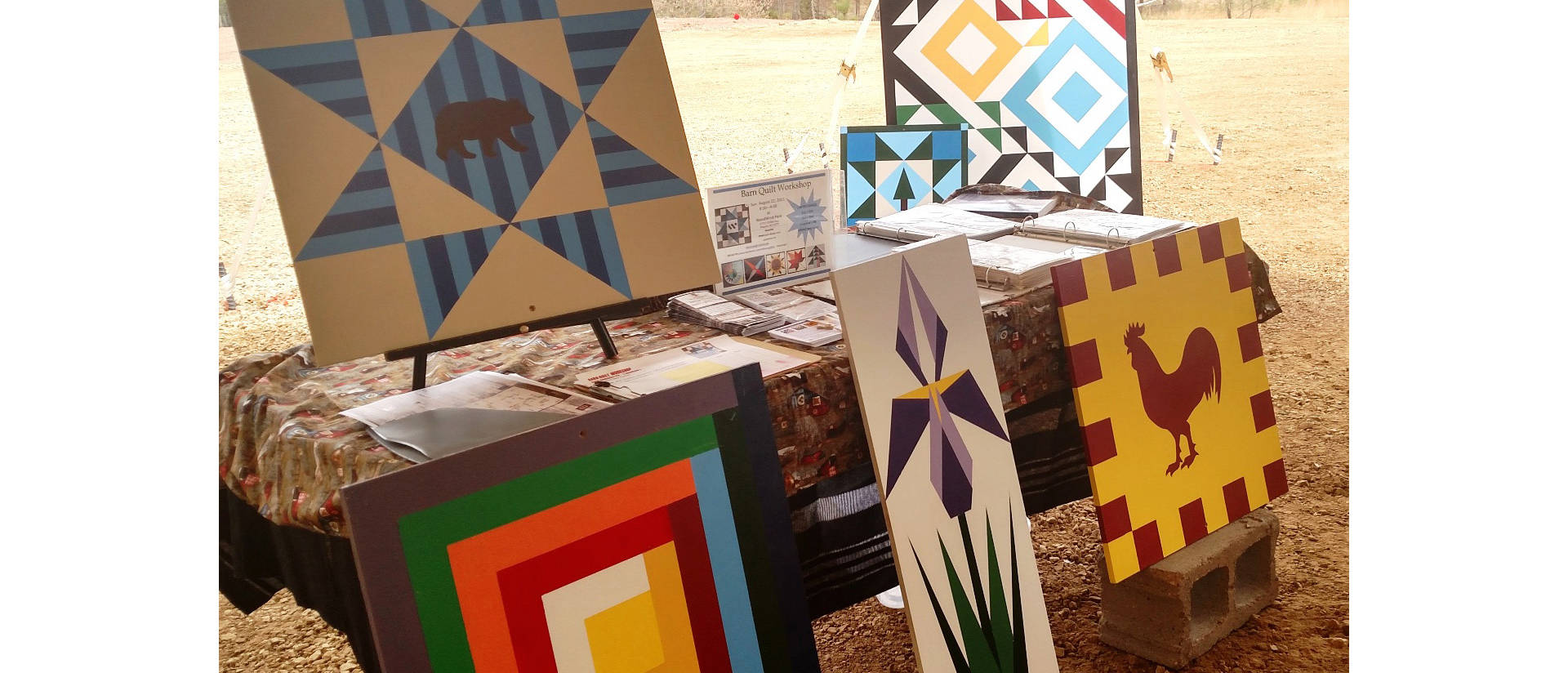 Several examples of barn quilt patterns were on display at the WoodWind Park Performance & Event Venue in Wheeler as part of their first craft fair in May. (Submitted photo)