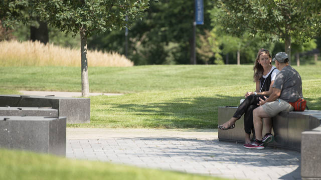 Faculty members sitting outside talking