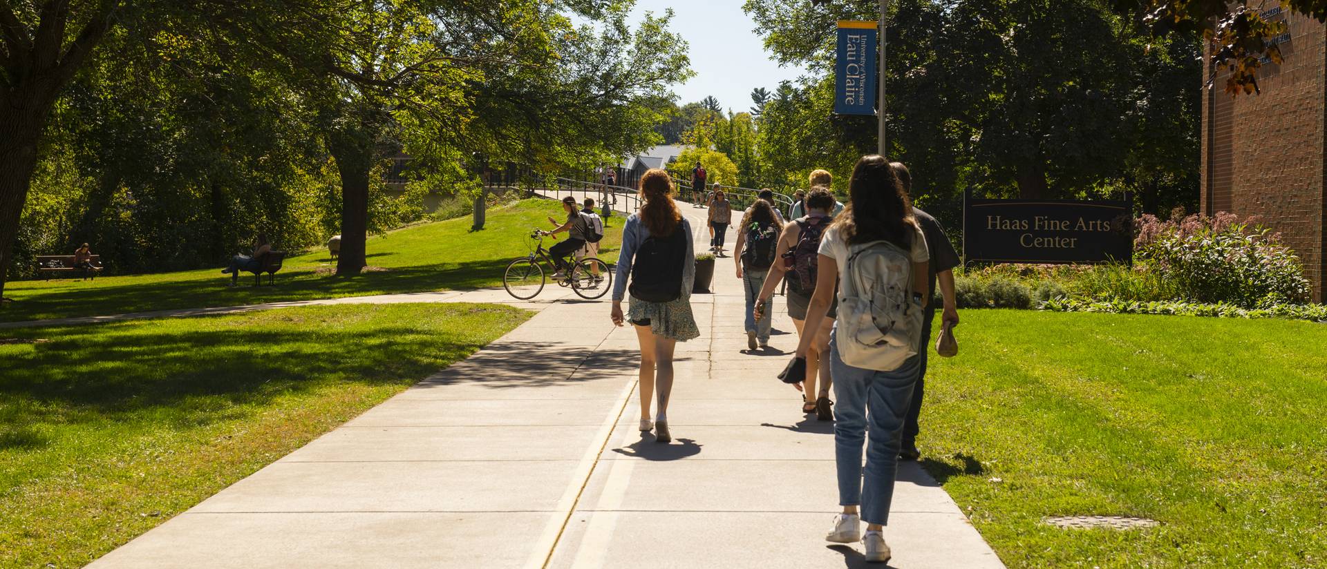 Students approaching footbridge near Haas Fine Arts Center