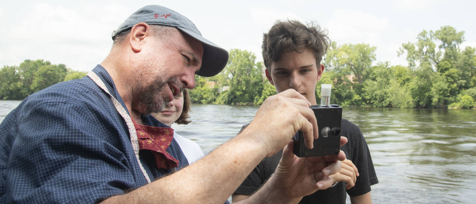 UW-Eau Claire geology professor Dr. J. Brian Mahoney shows high schooler Quinten Anger how to use a colorimetric kit to measure nitrate concentration in the Chippewa River. (Submitted photo)
