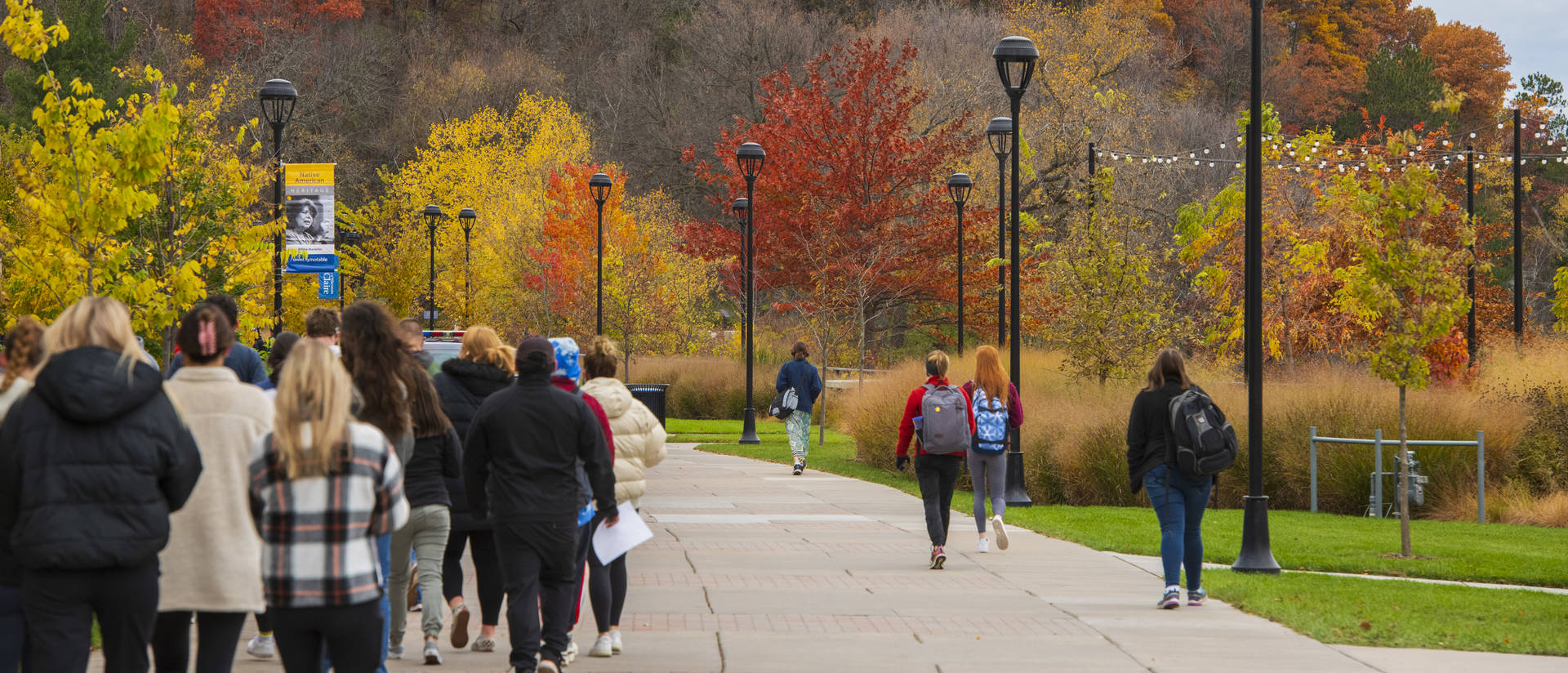 Students walking on campus in fall