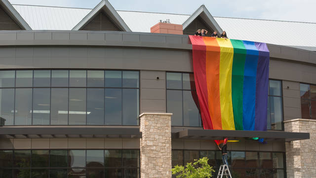 Photo of a pride flag hanging off of Davies Student Center