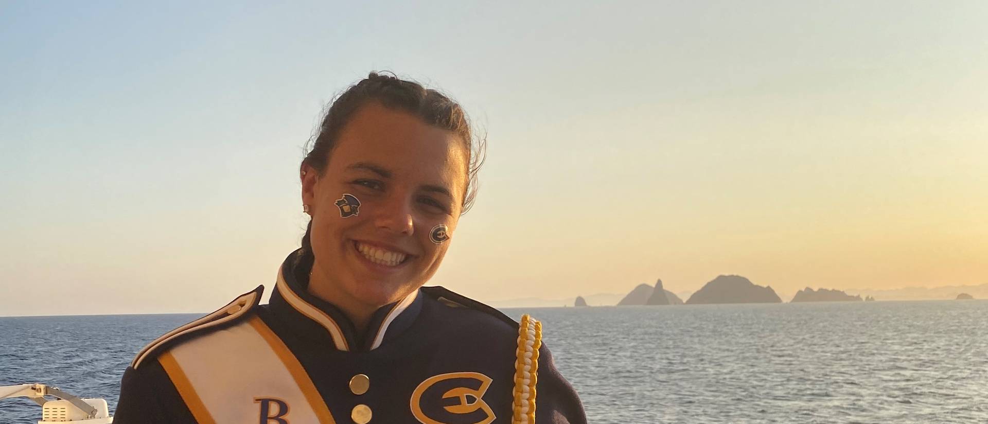 Girl in marching band uniform on the deck of a cruise ship