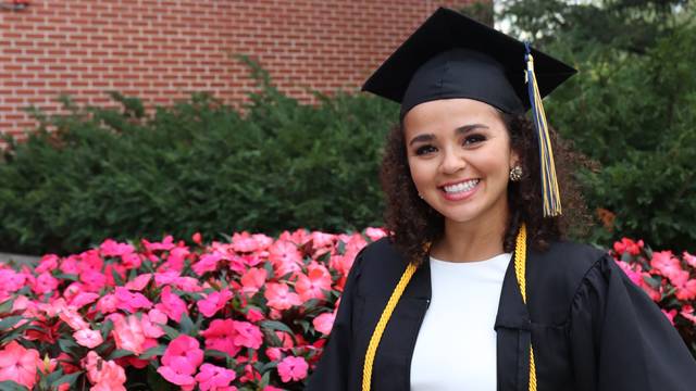 female student in cap and gown