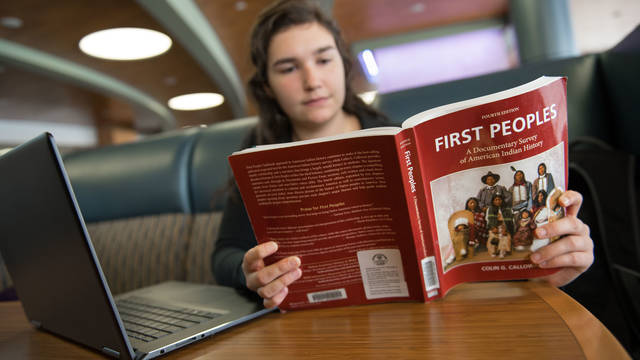 Student reading a textbook