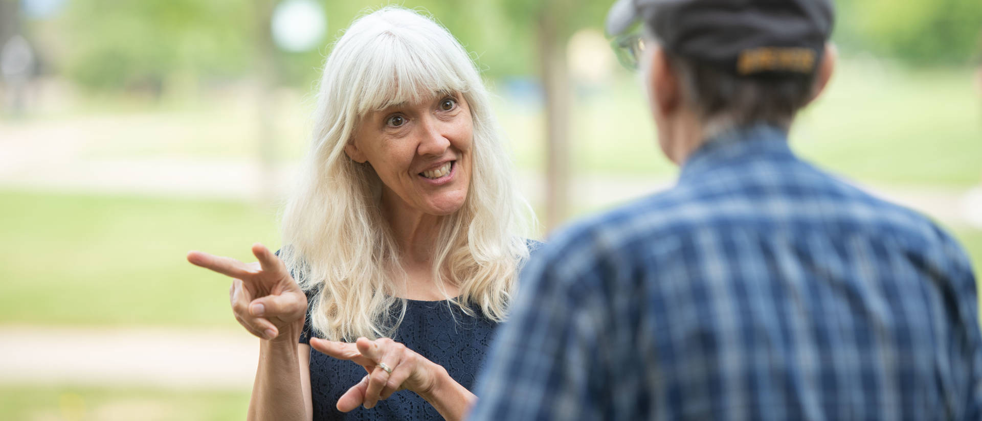 American Sign Language instructor speaking with community member