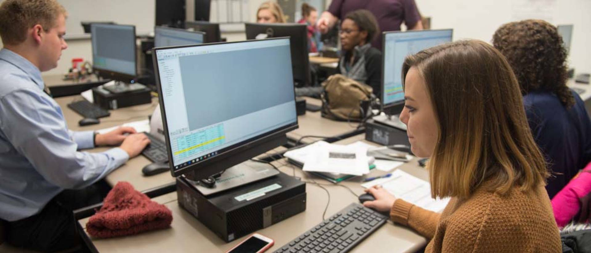 Communication students working on computers during class