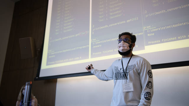Software engineering student presenting at a computer programming camp