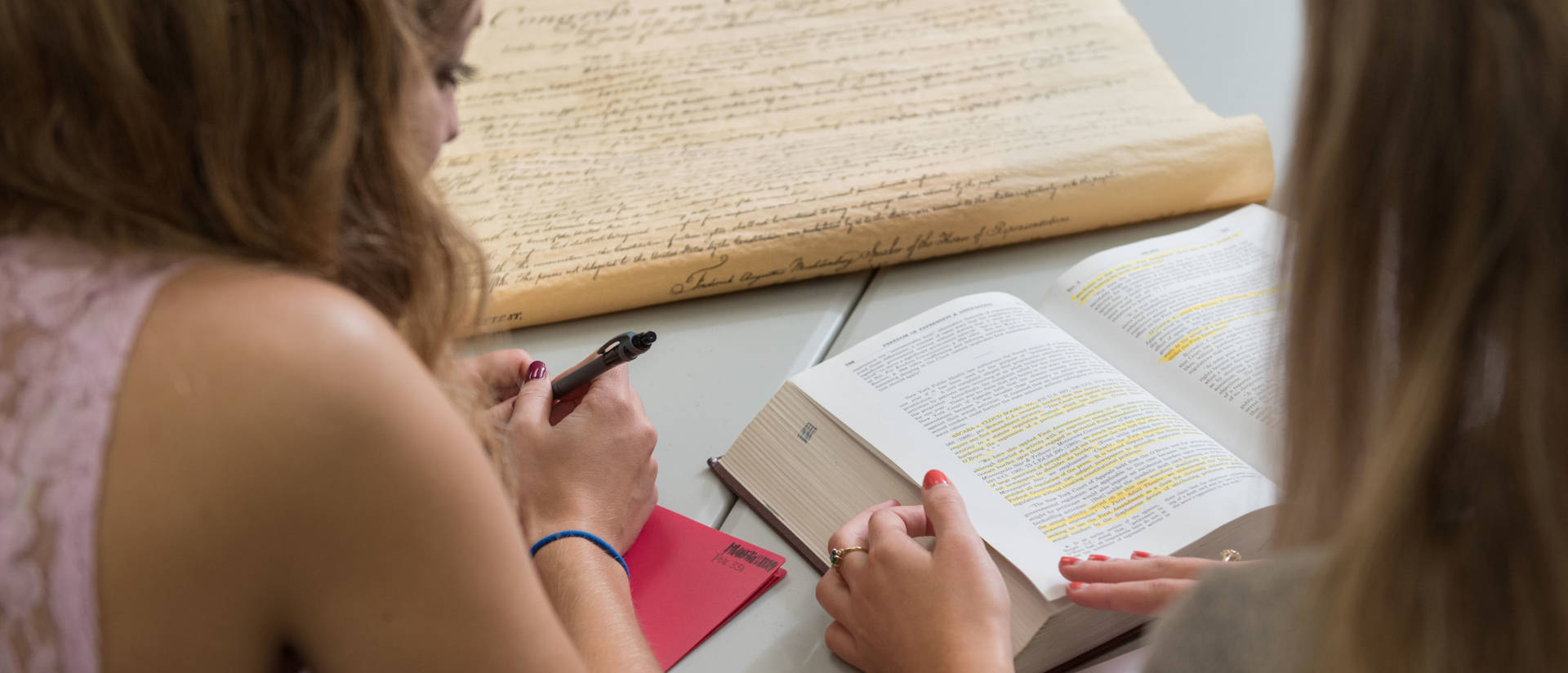 Two students discuss the Bill of Rights and U.S. Constitution in the Hibbard Hall Political Science study area