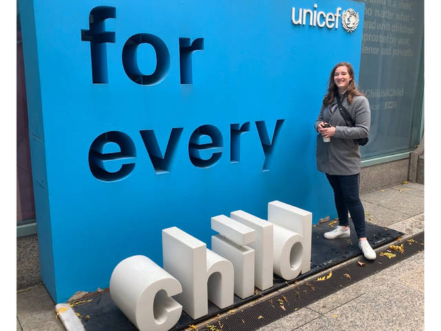 UW-Eau Claire student Kristina Tlusty stands in front of UNICEF sign