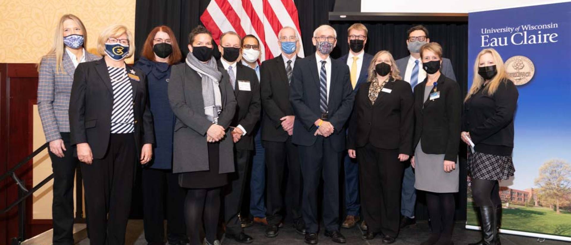 Gov. Evers, Mike Carney, Dr. Carmen Manning and team pose for photo.