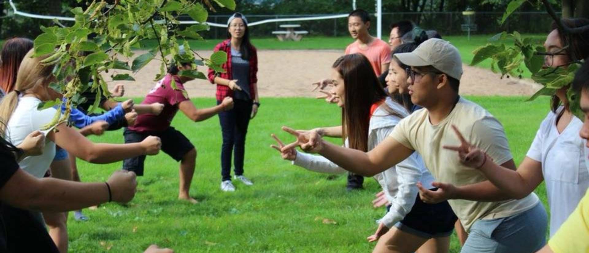 Students in the Hmong living community working together as a group outside