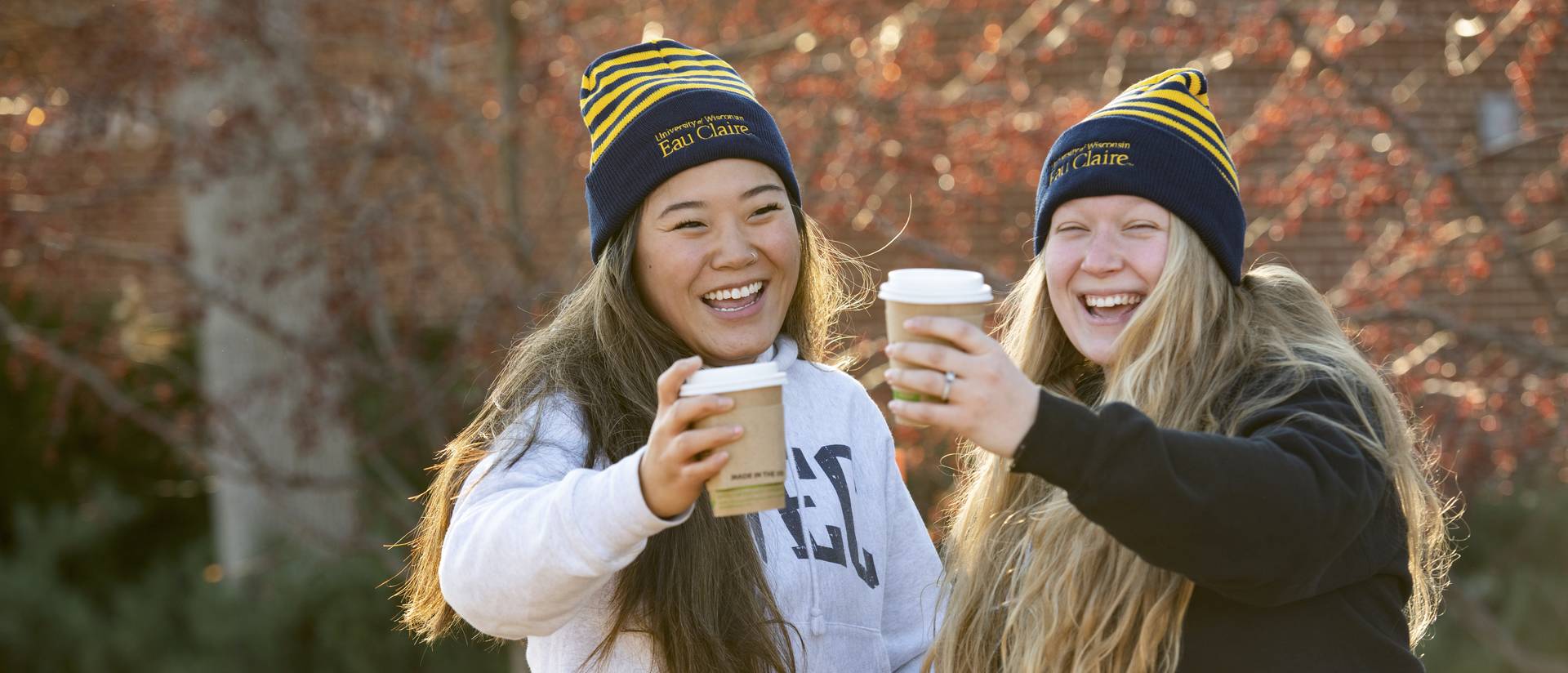 Two Blugolds holding coffees