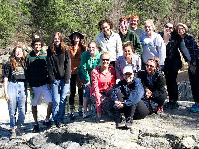 A group of Blugolds gather on a hike outdoors.