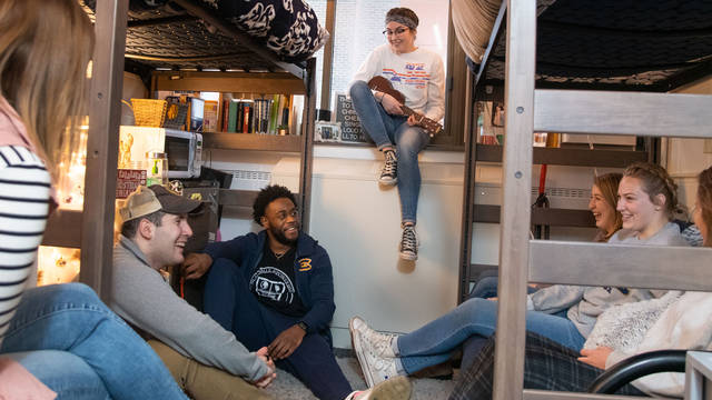 Students hanging out in residence hall room